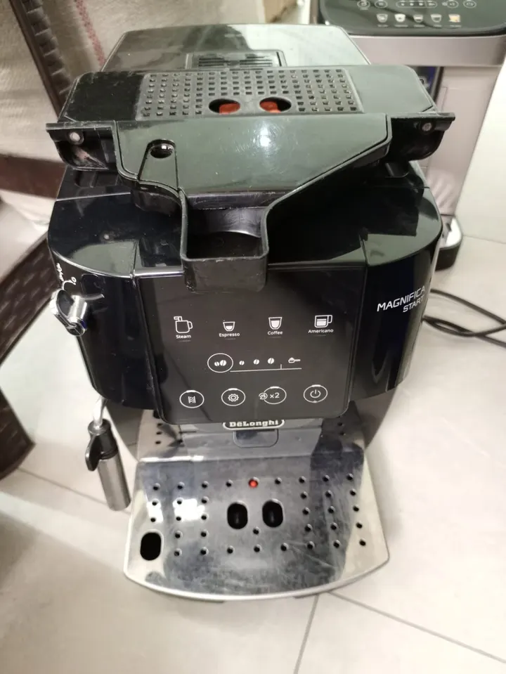 DeLonghi Magnifica Start bean-to-cup coffee machine with the top opened for service
