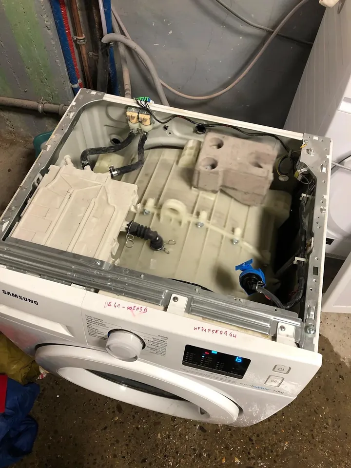 Samsung washing machine with the top off showing the inside