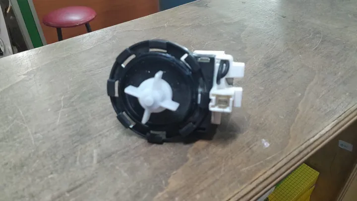 Washing machine drain pump removed for replacement